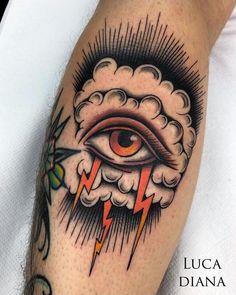 an eye with lightning coming out of it is on the arm and has clouds around it