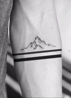 a man with a mountain tattoo on his arm