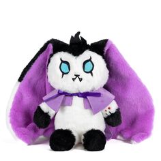 a purple and white stuffed animal with blue eyes