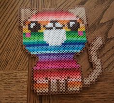 a cross stitch pattern of a cat with a rainbow on it's chest and eyes