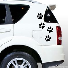 a white truck with black paw prints on the side