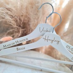 wedding hangers with names on them sitting on a table