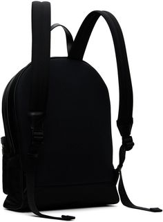 Nylon canvas backpack in black. · Buffed leather trim throughout · Carry handle · Adjustable padded shoulder straps · Logo embroidered at zip pocket · Padded mesh panel at back · Zip closure · Laptop compartment at interior · Card slot at interior · Taffeta lining · Logo-engraved silver-tone hardware · H15.75 x W13 x D4.25 Supplier color: Black no colour Black Coated Canvas Backpack With Adjustable Strap, Black Bags With Leather Backing For Commuting, Commuting Black Bag With Leather Backing, Black Commuting Bag With Leather Backing, Black Leather Backpack With Leather Trim For Travel, Black School Backpack With Leather Handles, Classic Black Leather Backpack With Leather Trim, Black Coated Canvas Bag For School, Luxury Black Leather Backpack In Coated Canvas