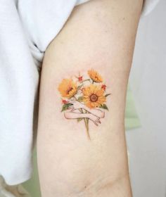 a woman's arm with sunflowers on it