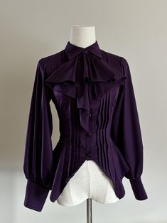 Add a touch of gothic elegance to your wardrobe with this stunning purple shirt. Featuring intricate pleating details on the front and long sleeves, this piece is perfect for adding a dark and romantic vibe to any outfit. The detachable jabot on the neckline adds an extra layer of drama and versatility to this unique top. Embrace your inner gothic style with this must-have shirt.   	 		 			Size 			S 			M 			L 			XL 		 		 			Full Length 			42-58 			43.5-60 			45-62 			46.5-64 		 		 			Sleeve Leng Spectra Inspired Outfits, Purple Romantic Goth, Black And Purple Clothes, Dark Purple Aesthetic Outfit, Dark Purple Clothes, Purple Witch Outfit, Purple Gothic Aesthetic, Goth Sleeves, Purple Dark Academia