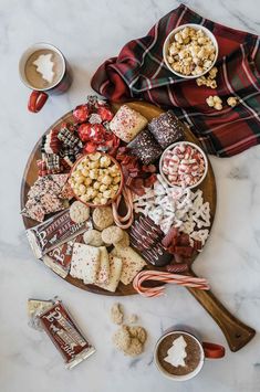 a platter filled with candy, marshmallows, and other holiday treats