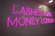 a neon sign that says lashes long money longer on the wall in front of a white wall