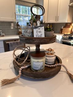 three tiered tray with candles and jars on top