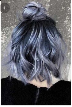 a woman with blue and grey hair is shown from the back