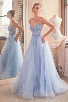 A woman poses in a light blue, strapless gown adorned with beads and tulle, reflecting in a mirror. Sunlight filters through a window, illuminating a vintage-styled room. Tulle Balls, Cinderella Divine, Strapless Bustier, Boned Bodice, Strapless Sweetheart Neckline, Prom Ball Gown, Beaded Tulle, Unique Prom Dresses, Strapless Corset