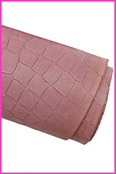 the pink leather is rolled up and ready to be used as a pillow or blanket