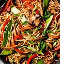 stir fry noodles with vegetables and mushrooms in a skillet