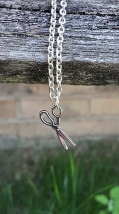 This cute, necklace has a scissors charm and would make a great gift for someone who loves to quilt or sew! The charm and chain are a silver color. The scissors measures 3/4 inch and you can choose the length of the necklace at checkout. This would make a great gift for a birthday, an anniversary, Christmas or any other occasion. All jewelry items come in a gift box. Handmade Cute Charm Necklaces For Mother's Day, Cute Charm Necklaces For Gifts, Novelty Silver Charm Necklace For Gift, Silver Novelty Charm Necklace For Gift, Tiny Adjustable Charm Necklaces As Gift, Novelty Necklace With Lobster Clasp For Gift, Handmade Adjustable Charm Necklaces For Birthday, Adjustable Handmade Charm Necklaces For Birthday Gift, Handmade Adjustable Charm Necklace For Birthday