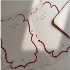 three envelopes with red and white designs on them