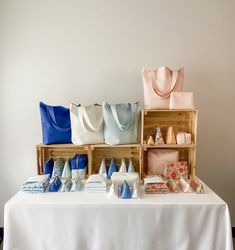 a table topped with lots of bags and purses