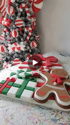 a decorated christmas tree with gingerbreads and candy canes in front of it