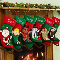 christmas stockings hanging from the fireplace in front of a fire place