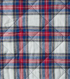 a blue, red and white plaid quilted material with squares in the center on top