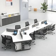 an office with multiple desks and chairs in it