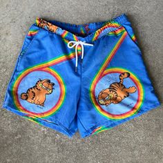 "This listing is for one pair of handmade Garfield shorts made from vintage sheets. The material is a cotton and polyester blend with little to no stretch. The shorts have a drawstring and two pockets that are large enough to hold a cellphone. The waist of these shorts is 34-36\" and the inseam is 6\". Shorts are 16\" from waist to hem. Please message me with any questions." Fun Relaxed Fit Shorts, Fun Shorts With Elastic Waistband, Playful Cotton Swim Trunks With Built-in Shorts, Retro Cotton Shorts With Elastic Waistband, Playful Shorts With Pockets For Vacation, Playful Vacation Shorts With Pockets, Playful Beach Shorts With Pockets, Cotton Swim Trunks For Summer Leisure, Leisure Cotton Swim Trunks For Summer