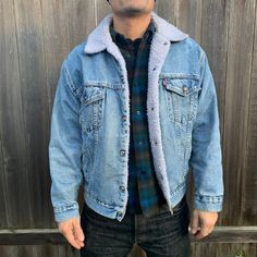 "This denim jacket is well made by Levi in the USA, the jacket is lightly worn but still sturdy and the vintage wear gives it a great worn in look. Beautiful steel snaps complete this classic button up jacket. White synthetic shearling and 100 cotton denim. The classic leather tag shows the size M underneath it. Jacket is men's sizing but is a unisex design. -Model size women's medium/large. -Model size men's large. Approximate measurement when laid flat: 25\" armpit to armpit 21\" shoulder to s Classic Denim Jacket, Denim Jean Jacket, Light Blue Denim, Blue Denim Jeans, Vintage Wear, Classic Leather, Denim Jean, Design Model, Vintage Levis