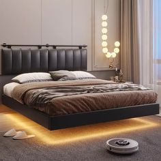 a bed with lights on the headboard and foot board