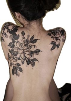 the back of a woman's body with flowers on it