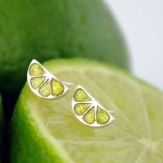 Silver earrings with the shape of a lime slices. Green ink transparent enamel."too sweet to resist the temptation"Press back earrings.Dimensions 11x5x2,3mmCOLLECTION➤ The design belong to the collection " Joyas Sabrosas" (Tasty Jewels)If you have any questions, please contact me. I will be very happy to help you.NOTE➤ All our designs are handmade, the color may be slightly different from one to another and from the ones shown in the photo.The piece shown in the picture is not real size. The phot Neon Yellow Drop Earrings As A Gift, Neon Yellow Jewelry For Summer Gift, Summer Gift Jewelry In Neon Yellow, Gift Lime Green Sterling Silver Earrings, Lime Green Sterling Silver Earrings For Gift, Brunch Club, Fruit Jewelry, Oranges And Lemons, Earrings Green