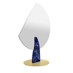 a blue and white sculpture sitting on top of a wooden table next to a mirror