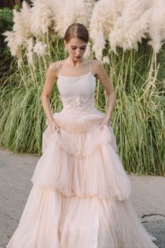 a woman in a dress standing on the street