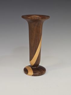 a tall wooden vase sitting on top of a table