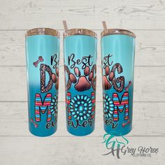 three blue tumblers with the words best mom and two dogs on them, sitting next to each other