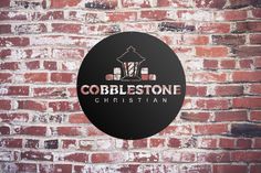 cobblestone christian church sign on a brick wall