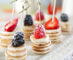 small desserts with strawberries and blackberries on them