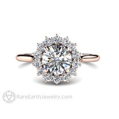 an engagement ring with a halo setting and round diamonds on the band, set in 18k rose gold