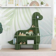 a green dinosaur book shelf in a children's room