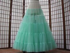 "The pictured petticoat was a custom order for a bride. The reason for the ivory top is so that the mint green color does not cast a shadow underneath the very fitted torso of her ivory gown. The design of this petticoat is so that the most fullness is at the hem of the skirt with little to no added fullness in the hip area. This sale is for a custom version of the pictured mint green and ivory single layer petticoat made out of soft nylon chiffon. The waist will be .75\" (2cm) wide elastic that Fitted Green Petticoat For Spring, Fitted Spring Wedding Petticoat, Ivory Gown, Mint Green Color, Future Style, Ivory Tops, Polyester Satin, Petticoat, Victorian Fashion