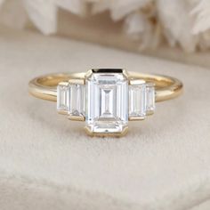 an engagement ring with three baguets on it