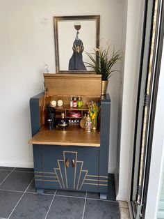 a blue and gold cabinet with plants on top