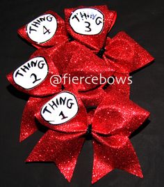 red glitter hair bow with thing two and thing three written on the top in white letters