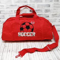 WHY THIS ONE IS SPECIAL: This personalized Soccer bag has black and white applique and gray accents, on a custom bag color. Perfect to to hold all your stuff whether for after school practice, competitions or even a weekend at grandma's! Add a name for a super personalized on the go bag. The HMTO Guarantee: Hand Made To Order means this product is not premade, so this item will be unique and hand crafted just for you! Current Production Times. THREE GREAT STYLES: TOTE bag measures 12x18"with a z Rectangular Black Bag For Sports Events, Functional Rectangular College Bags, Functional Rectangular College Bag, Black Bags For Sports With School Spirit Style, Red Rectangular Sports Bag, Sporty Travel Bag With Embroidered Logo, Customizable Sporty School Bags, Sporty Customizable School Bags, College School Spirit Bags For Back To School