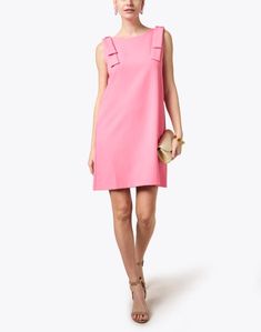 This pink sleeveless shift dress by Abbey Glass is a modern take on a classic look. With bows on each shoulder and a high boat neckline, this dress is the epitome of classy femininity. With a quick switch of accessories, take this look from day to evening. Chic Bow Mini Dress For Daywear, Chic Mini Dress With Bow For Daywear, Chic Pink Sleeveless Evening Dress, Chic Pink Sleeveless Dress For Cocktail, Chic Pink Sleeveless Cocktail Dress, Elegant Bow Mini Dress For Daywear, Elegant Mini Dress With Bow For Daywear, Elegant Sleeveless Dress With Bow For Spring, Elegant Sleeveless Spring Dress With Bow