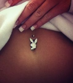 a pregnant woman's belly with an origami pin attached to it