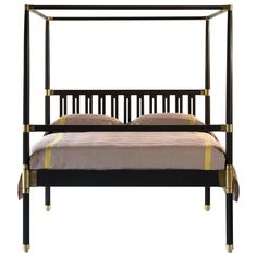 an iron bed frame with beige sheets and pillows on it, against a white background