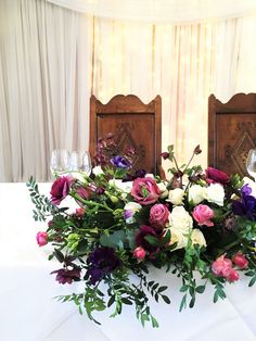 a table with flowers and wine glasses on it