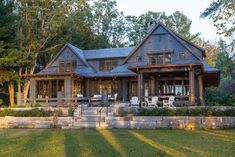 a large house sitting on top of a lush green field