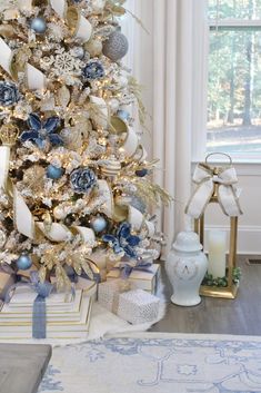 a christmas tree decorated with blue and gold ornaments