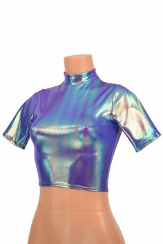 "This item is made to order, please read all the way through the listing before purchasing! This shiny, liquidy holographic top has a smooth reflective finish that bends the light in beautiful shifting rainbows. It features a high short collar neckline and cute little tee length sleeves. Four way stretch spandex for a great fit! TOP LENGTH: Underarm to hemline measures 8\" Womens Sizing (See below for instructions on where measurements should be taken) XXS: Bust 29\"-30\" / Waist 22\"-23\" / Hip Trendy Fitted Shiny Tops, Metallic Shiny Disco Top, Metallic Shimmer Top For Disco, Metallic Shimmer Disco Top, Metallic Shiny Fitted Crop Top, Fitted Metallic Shiny Crop Top, Metallic Shiny Fitted Tops, Fitted Metallic Shiny Tops, Fitted Iridescent Tops