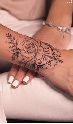 a woman's arm with a rose tattoo on it