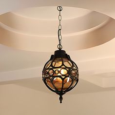 a chandelier hanging from the ceiling in a room with white walls and ceilings